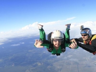 Your instructor will keep a grip on you while you learn to maintain a stable freefall body position, giving hand signals for corrections if needed.